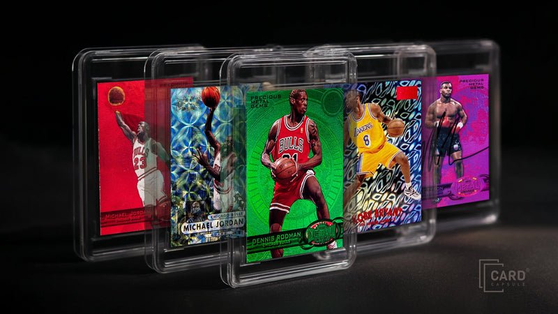 Five sports cards in clear magnetic one-touch holders, fanned out on a dark background