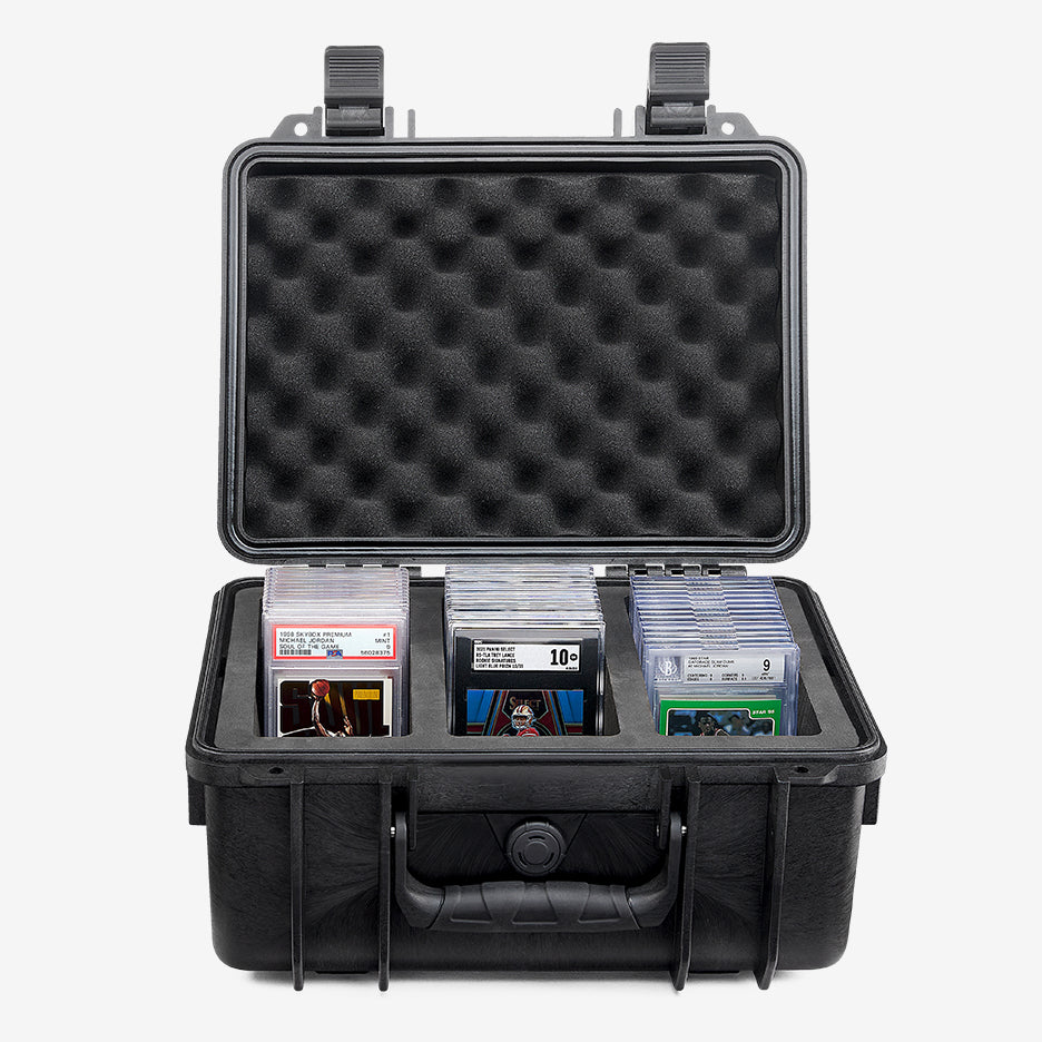 Card Capsule case open, three compartments loaded with graded slabs under a convoluted foam lid
