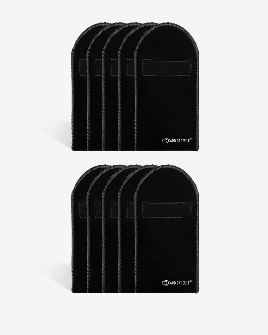 Two stacks of black velvet Card Capsule graded card bags, showing bulk quantities