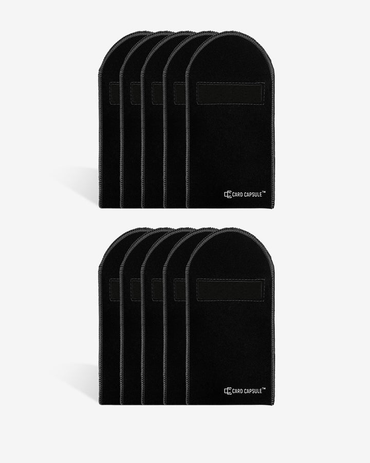 Two stacks of black velvet Card Capsule graded card bags, showing bulk quantities